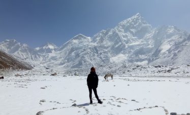 a girl enjoying her view in the kala patthar route from ebc on the ebc trekking trail in the khumbu region also known as the everest region.