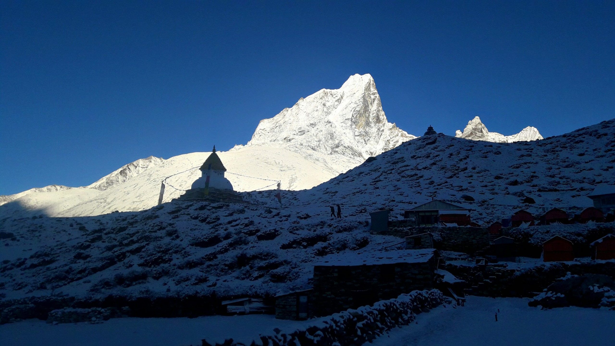 a view as seen from dingboche, in the background stands a chaitya also a small temple in the ebc trekking trail of everest region also known as khumbu region