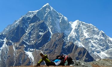 a woman in front of lola pass in the everest region during the Everest Base Camp trek.
