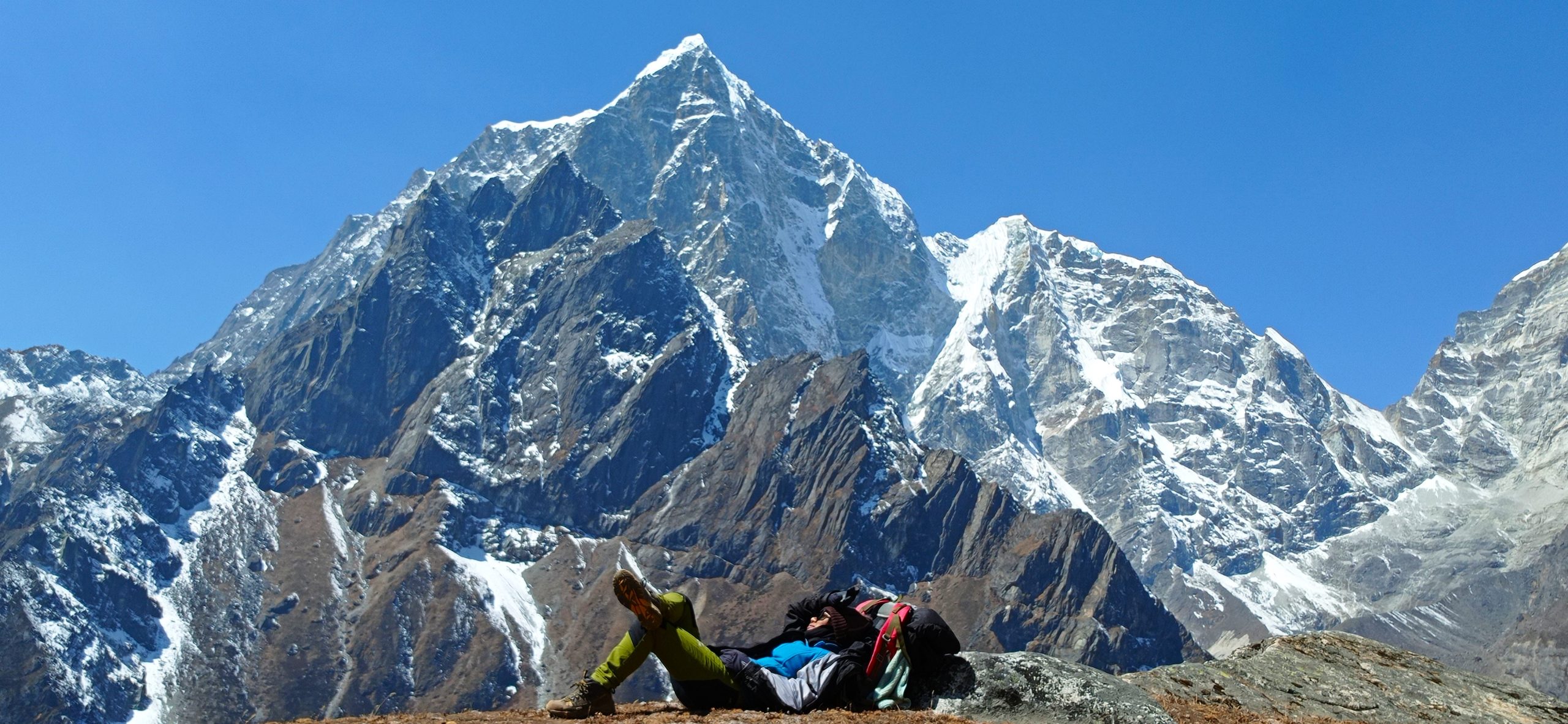 a woman in front of lola pass in the everest region during the Everest Base Camp trek.