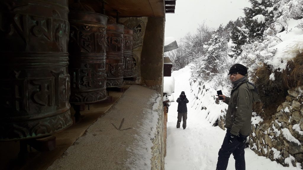 trekkers take turn to roam around the prayer stones in the Namche Bazaar of Solukhumbu, Nepal