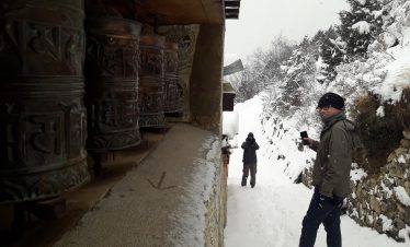 trekkers take turn to roam around the prayer stones in the Namche Bazaar of Solukhumbu, Nepal
