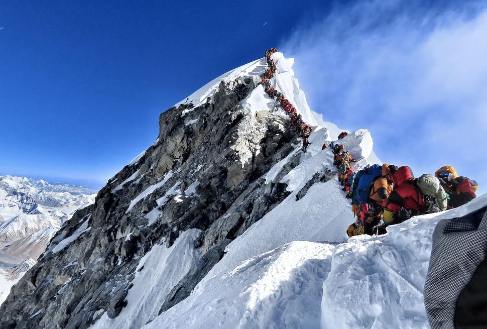 Climbers standing in queue in order to summit the Mount Everest.